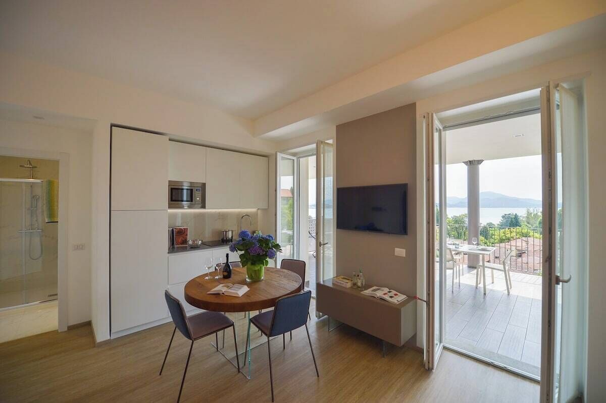 Eine moderne Küche mit Essbereich, einem Flachbildfernseher und Blick ins Freie.