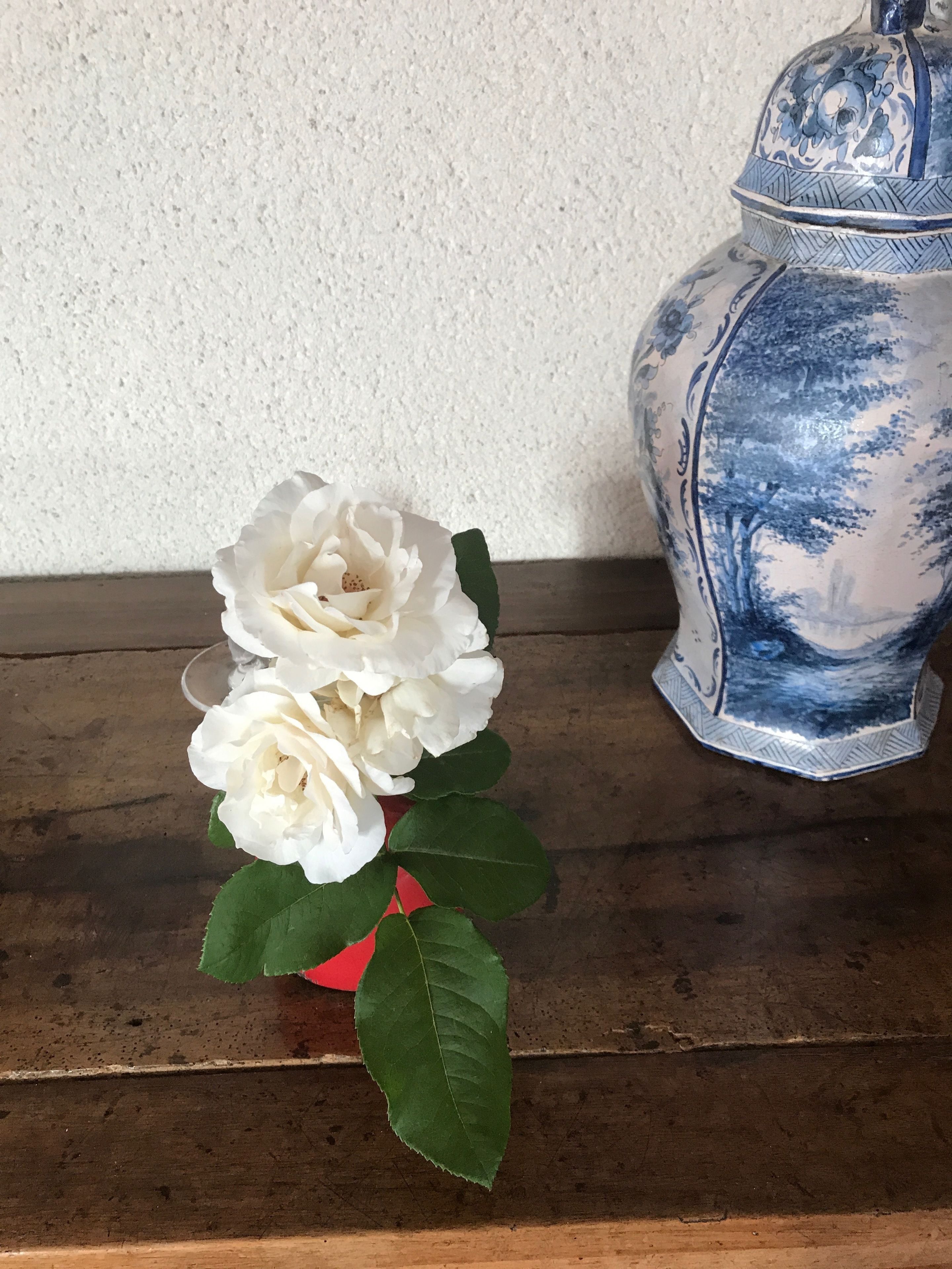 A vase with a blue and white floral pattern on a wooden surface.