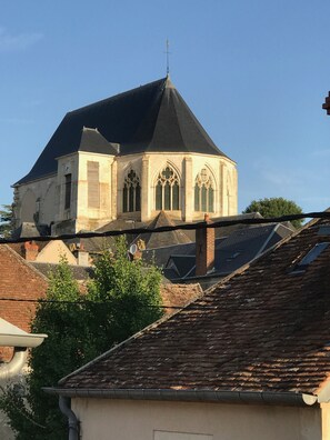 A historic building with a pointed roof and arched windows, surrounded by residential buildings. - La Chancelière (Saint-Satur)