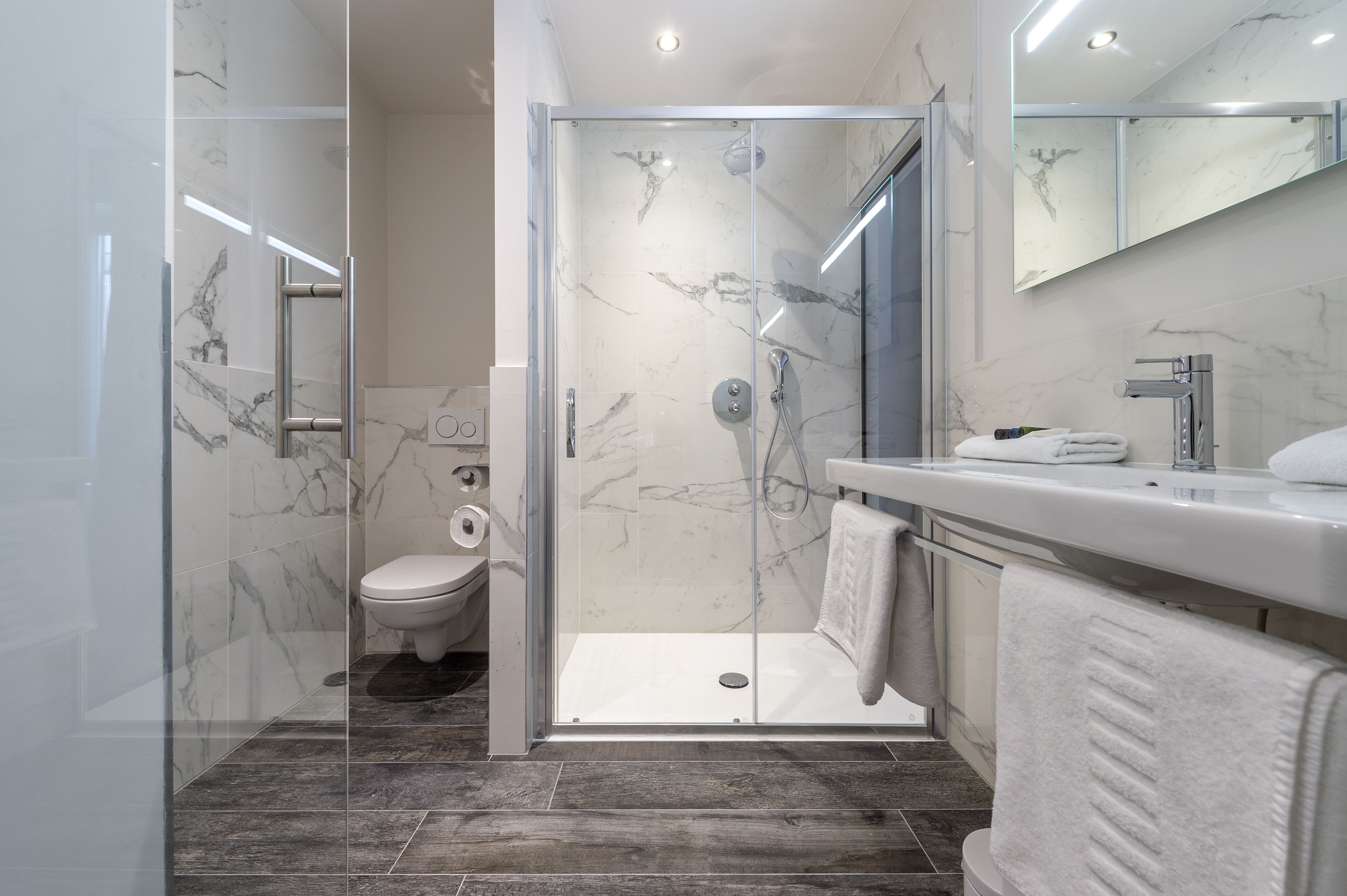 deep-soaking bathtub, rainfall showerhead, towels