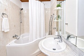 A modern bathroom with a bathtub, a shower, and a sink. - Apartment Bosiljka (Rogoznica)
