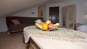 A cozy room with a bed, a wooden wardrobe, and a fruit bowl on the bedside table. - Apartments Katarina (Vodice)