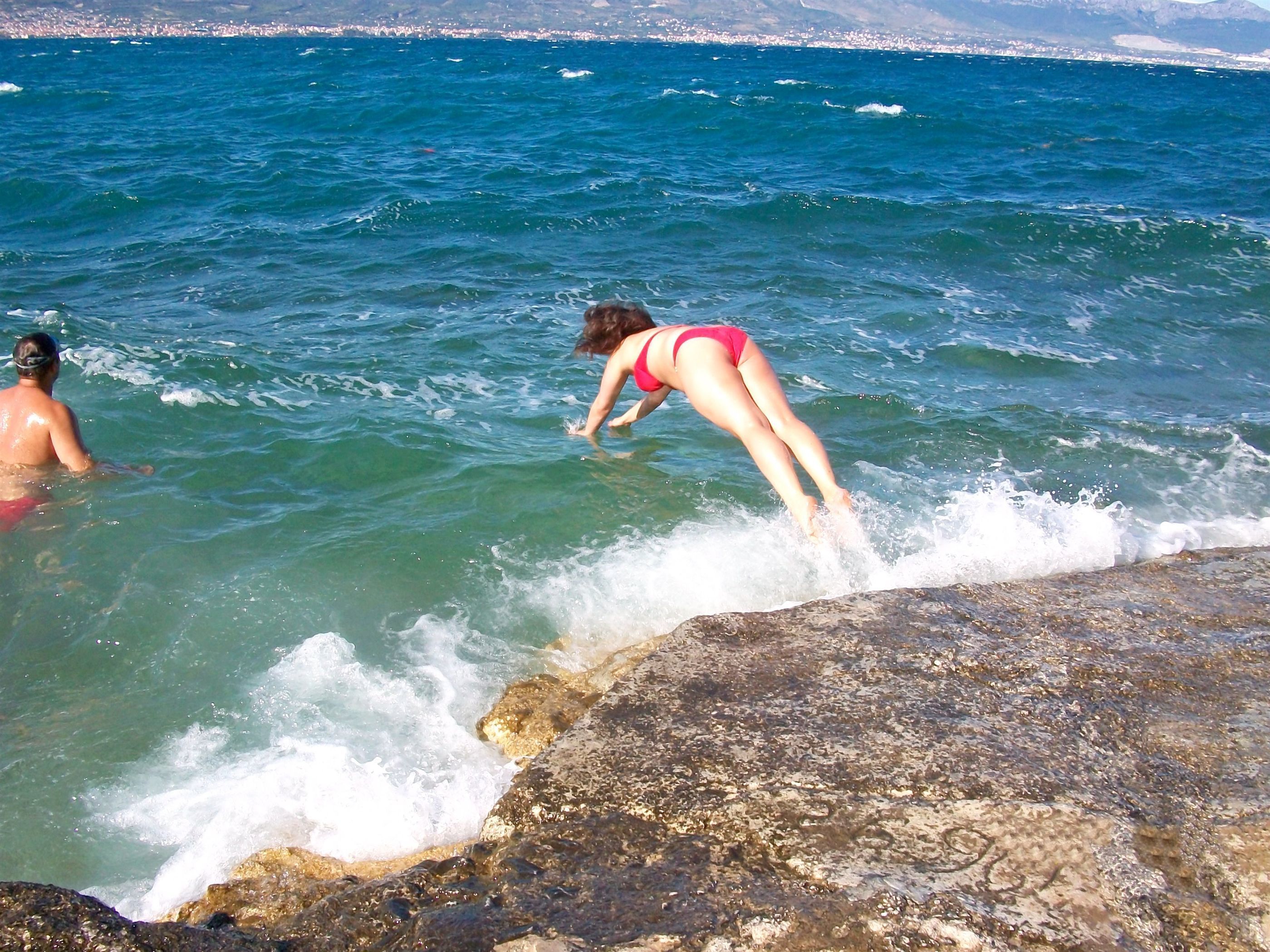 A rocky shoreline with clear blue water.
