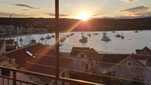 A harbor with multiple boats at sunset. - Apartments Vladimir (Primosten)