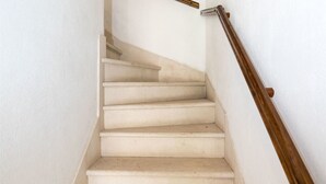 A staircase with white walls and wooden handrails. - House Sanda (Kastel Novi)