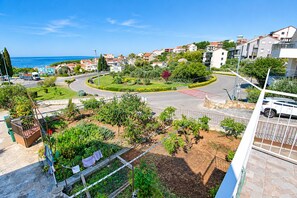 A residential area with a roundabout, greenery, and a view of the sea. - Apartment Lele (Primosten)