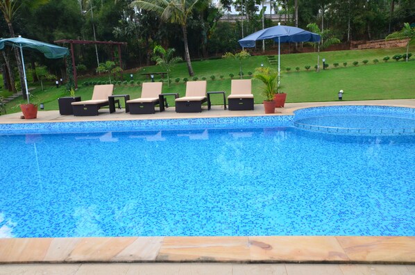 Outdoor pool, an infinity pool, open 9:00 AM to 8:00 PM, pool umbrellas