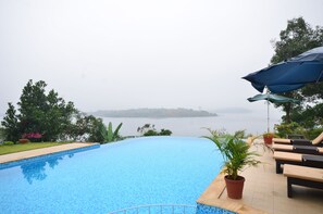 Outdoor pool, an infinity pool, open 9:00 AM to 8:00 PM, pool umbrellas - LakeRose Wayanad Resort (Vythiri)