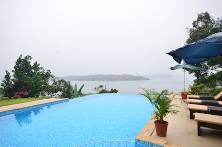 Outdoor pool, an infinity pool, open 9:00 AM to 8:00 PM, pool umbrellas