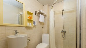 A bathroom with a sink, toilet, and shower. - Hanoi Cozy House (Hanoi)