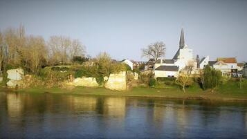 A riverside town with a prominent church, stone walls, and residential buildings.