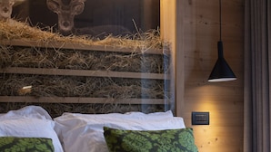 Un dormitorio con cama, almohadas y una cornamenta de ciervo montada en la pared.