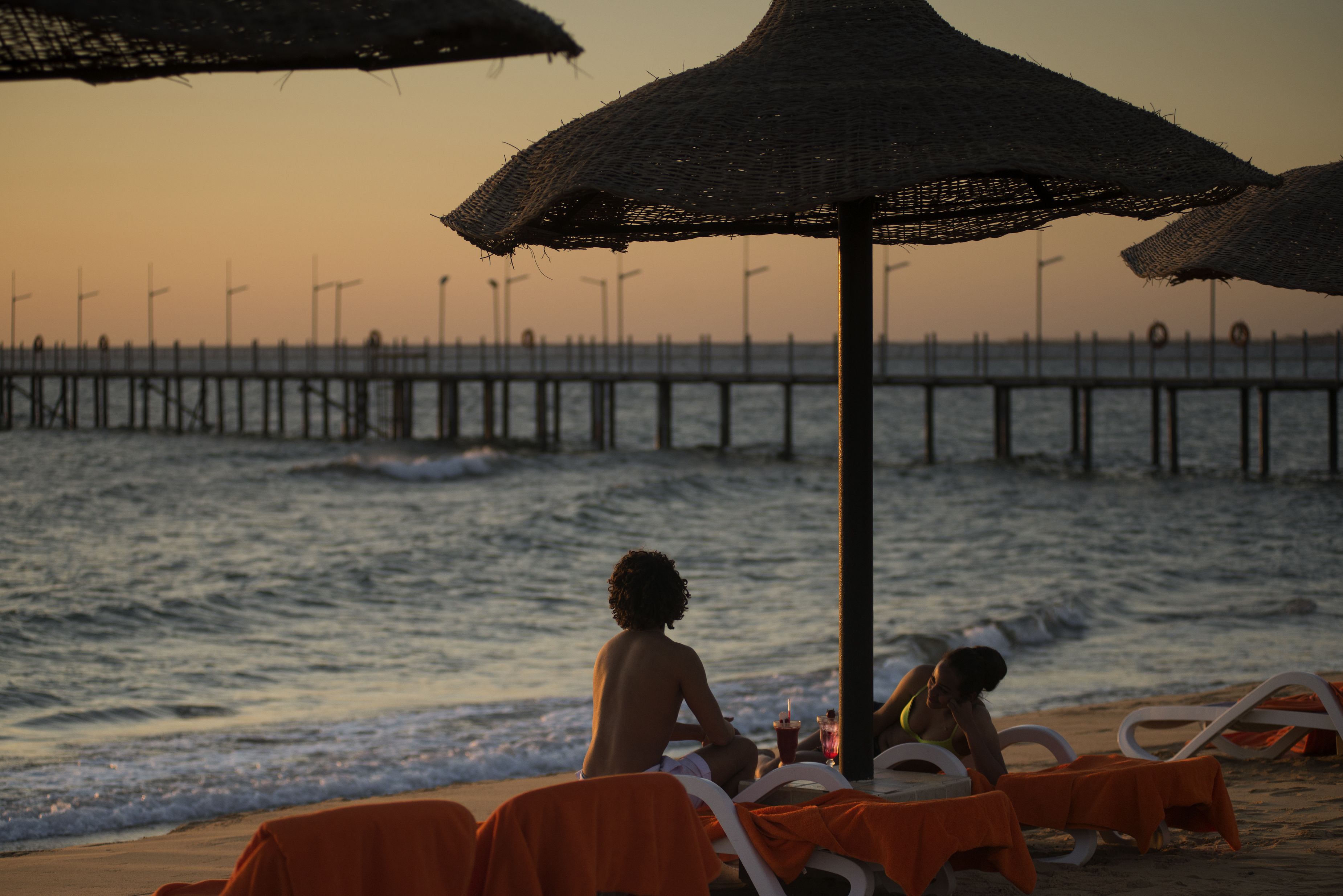 On the beach, beach umbrellas, beach towels, beach volleyball