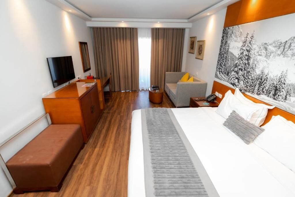 Deluxe Double Room, Sea View | Minibar, in-room safe, iron/ironing board, bed sheets