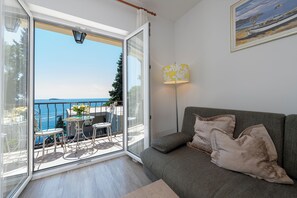 Apartment, Sea View | Living area | 100-cm flat-screen TV with digital channels