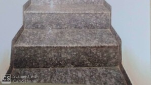 A staircase leading to a wooden door at the top. - Rajhuns Deluxe Lodging (Kolhapur)