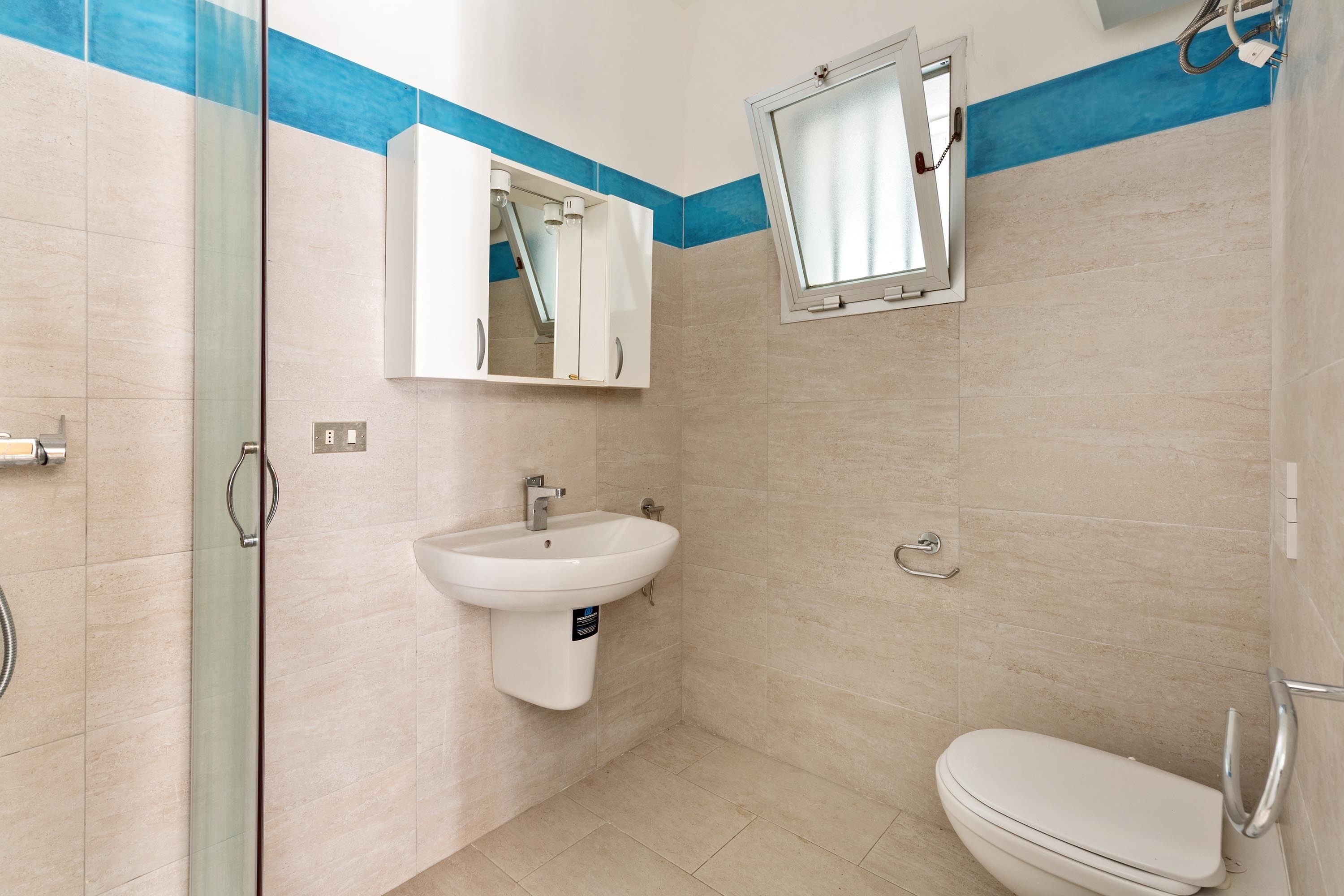 A bathroom with a sink, mirror, and toilet.