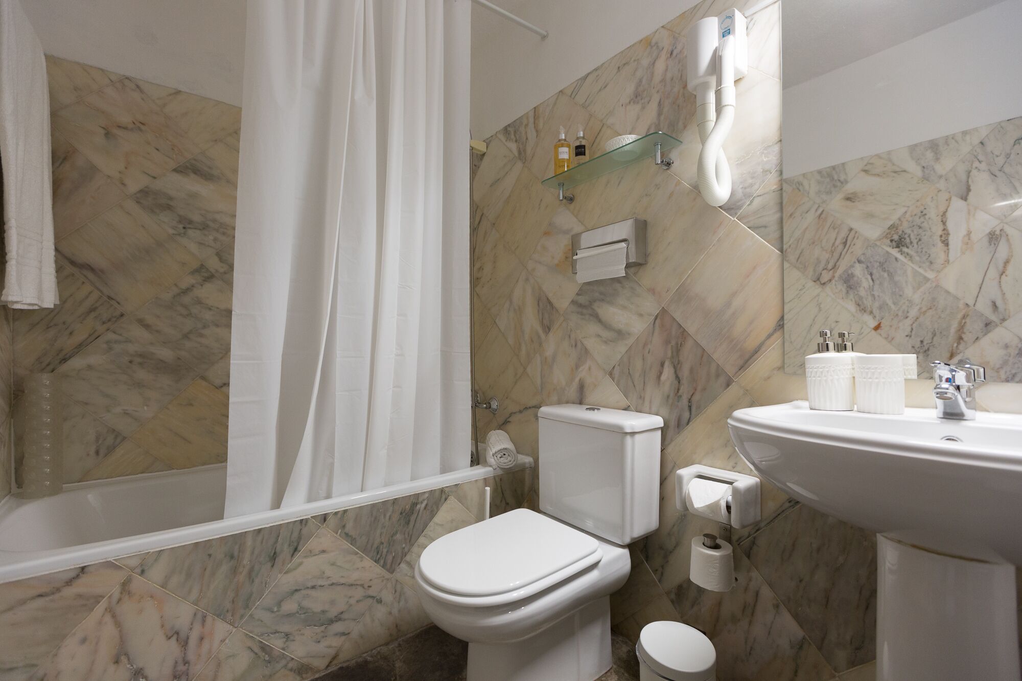 Ein Badezimmer mit Toilette, Waschbecken und Duschvorhang.