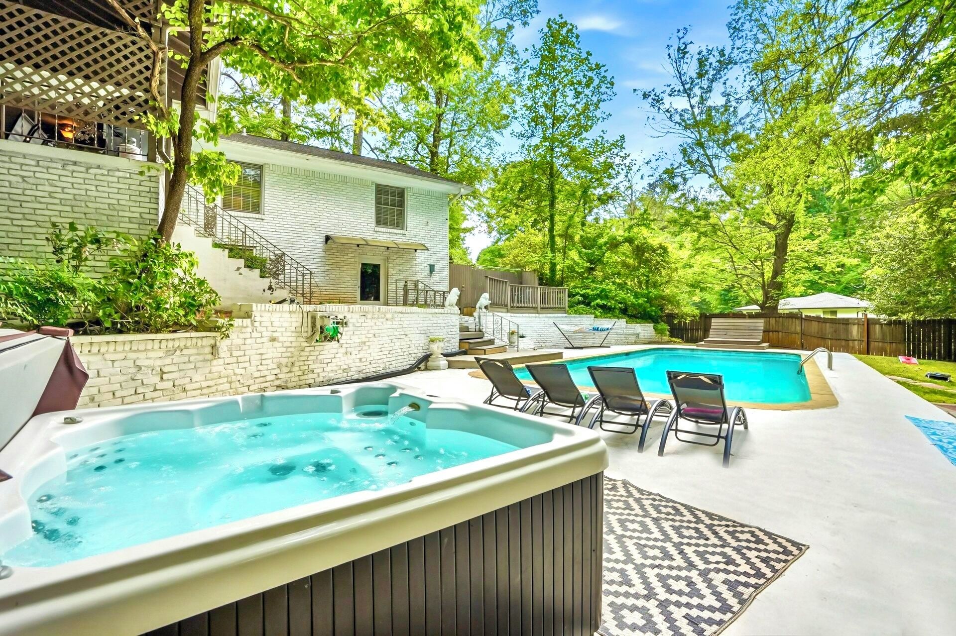 Backyard: multi decks, seasonal pool,year-round hot tub,seating,hammock,cornhole