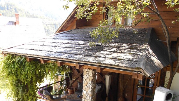 A wooden house with a stone staircase leading to a porch. - Cottage and Chalet Pr Klemuc (Bled)