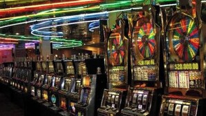 A row of slot machines in a casino with colorful neon lights above. - Now Open! 7-Night Deal – Oceanfront w/ Private Balcony & Stunning Views (Longboat Key)