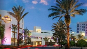A Hard Rock Casino building with palm trees and a clear sky. - Now Open! 7-Night Deal – Oceanfront w/ Private Balcony & Stunning Views (Longboat Key)