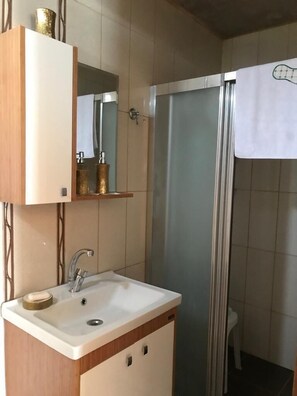 Shower, hair dryer, slippers, towels