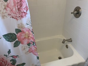 Bathtub, hair dryer, towels, soap