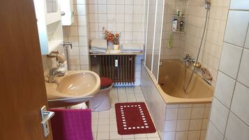 Bathtub, hair dryer, towels, soap