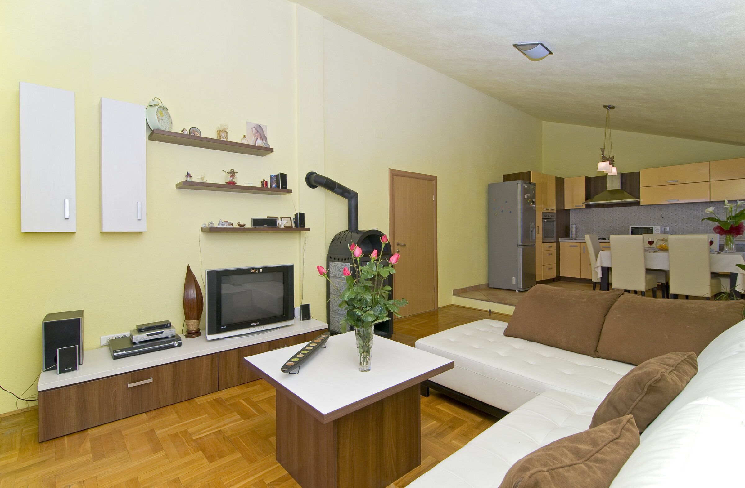 Spacious living room is connected with kitchen and balcony.