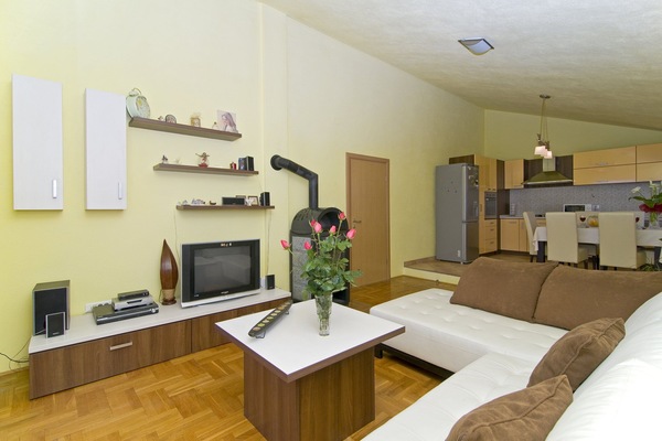 Spacious living room is connected with kitchen and balcony.