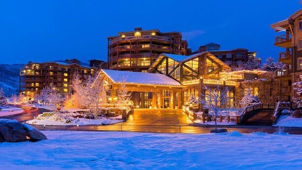 A multi-story hotel with a snow-covered entrance and illuminated windows. - Luxury Studio!! Gym, Pool, Sauna, Spa, Canyons Gondola Ski In/Out (Park City)