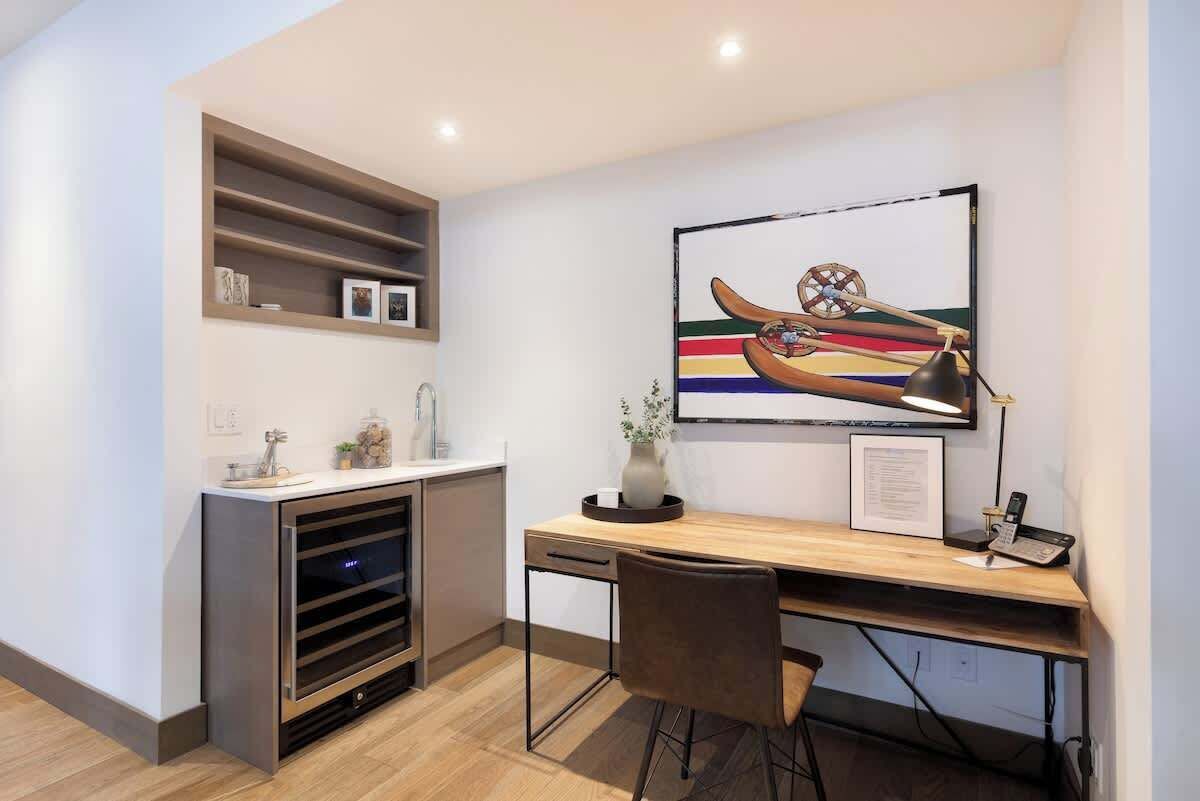 A modern kitchen with a built-in oven, a wooden countertop, and a wall-mounted shelf.