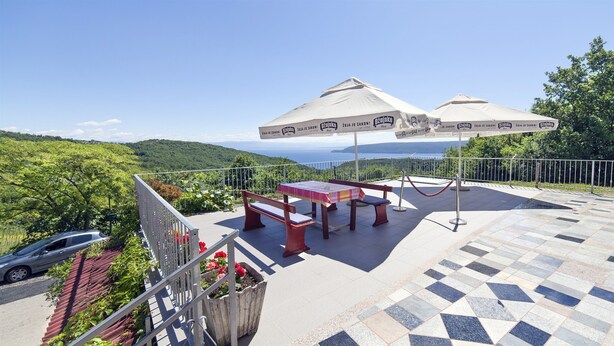 A terrace with a table and benches, overlooking a scenic landscape. - Apartments Andela (Brsec)