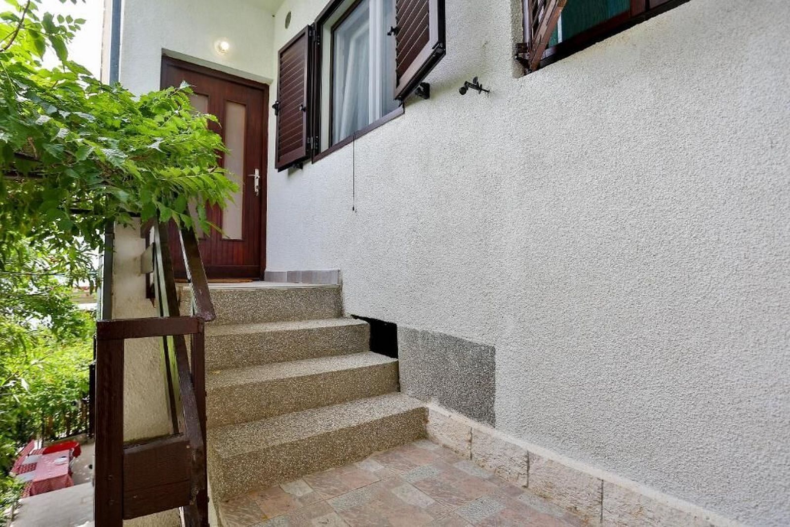 A staircase leading to a door with a window above it.