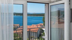 A balcony with a view of a body of water and buildings.