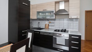 A modern kitchen with a dishwasher, stove, and built-in oven.
