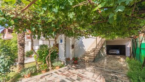 A courtyard with a tiled floor, a staircase, and a car parked inside a building. - Apartment Dorijana (Porec)