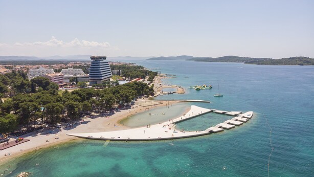 A coastal area with a beach, a water park, and a tower. - House Rajka I (Vodice)