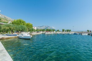 Stroll along the waterfront, surrounded by boats and scenic views of the nearby mountains.