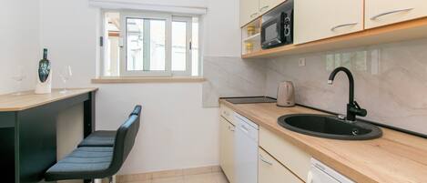 Apartment (A1) | Private kitchen | Fridge, microwave, stovetop, dishwasher