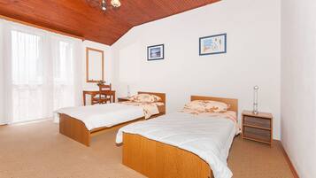 Laptop workspace, iron/ironing board, bed sheets