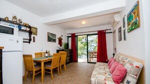 A compact living space with a kitchenette, dining area, and a sofa. - Apartment Dijana (Crnja Luka)