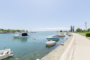 Stroll along the marina's concrete walkway, surrounded by calm waters and serene views.