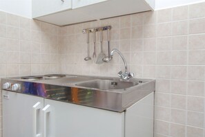 Fridge, espresso maker, coffee/tea maker, cookware/dishes/utensils