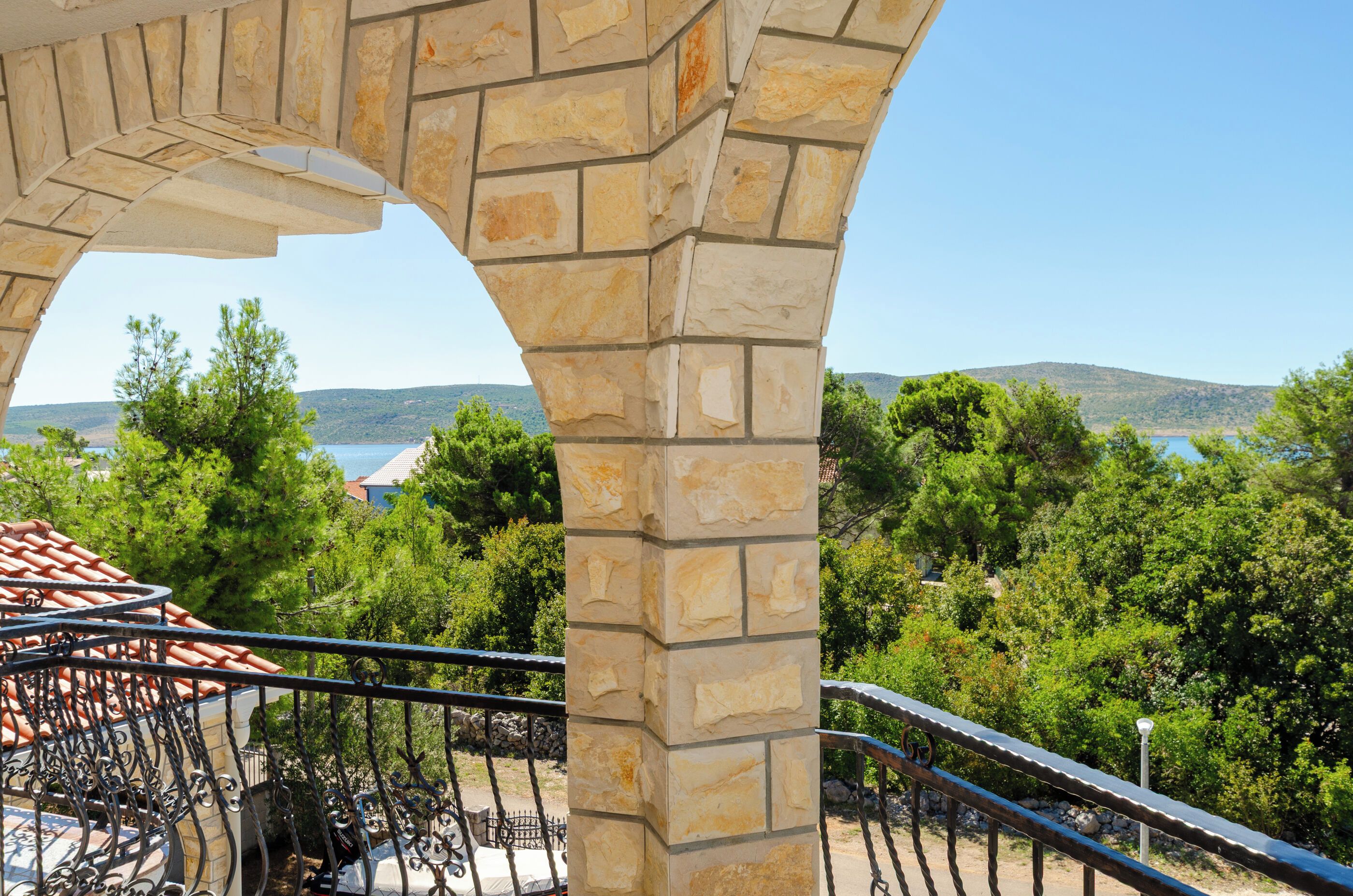 A stone structure with a view of a mountainous landscape and a body of water.