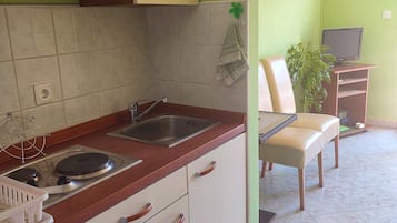 Studio (A2) | Privékeuken | Een koelkast, een kookplaat, kookgerei, borden en bestek