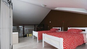 A bedroom with two beds, a white ceiling, and a view of a balcony. - Apartments Grzic (Porozina)