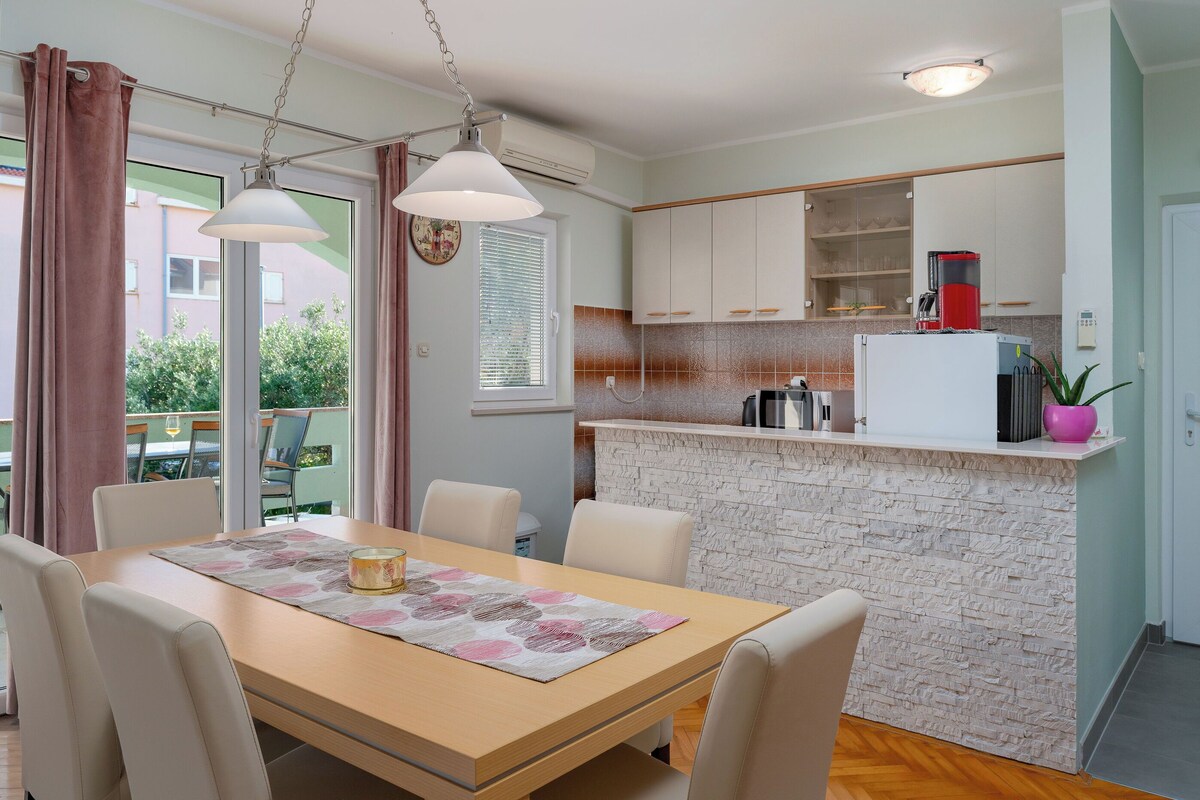 A dining area with a wooden table, white chairs, and a decorative placemat.