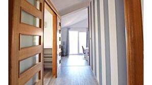 A hallway with wooden doors and a staircase leading to another room. - Apartments Branka (Starigrad - Paklenica)